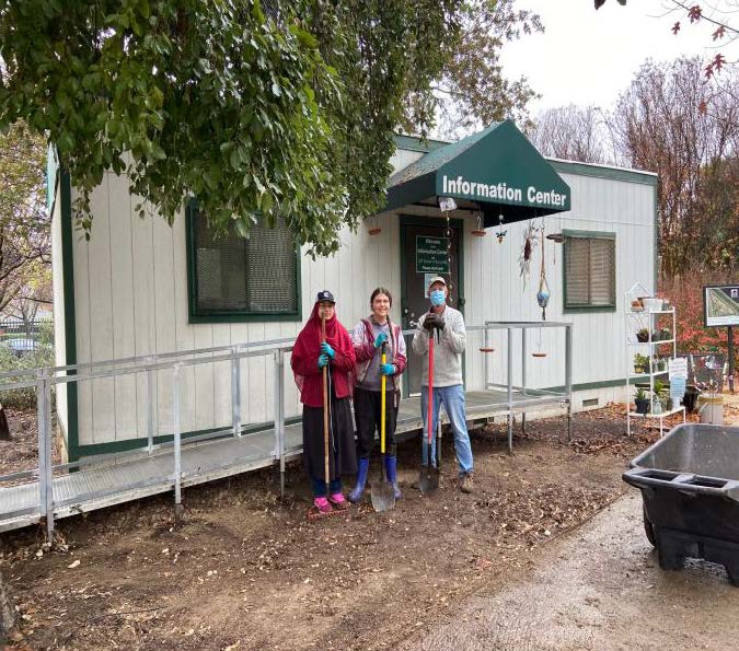 Mishaal Hasan, Aleja Anderson & John Damrose standing with cleaning equipment