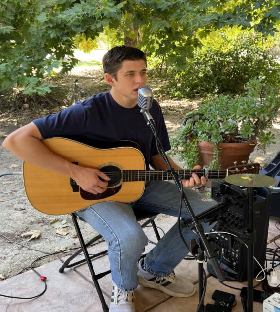 young man sing while playing guitar